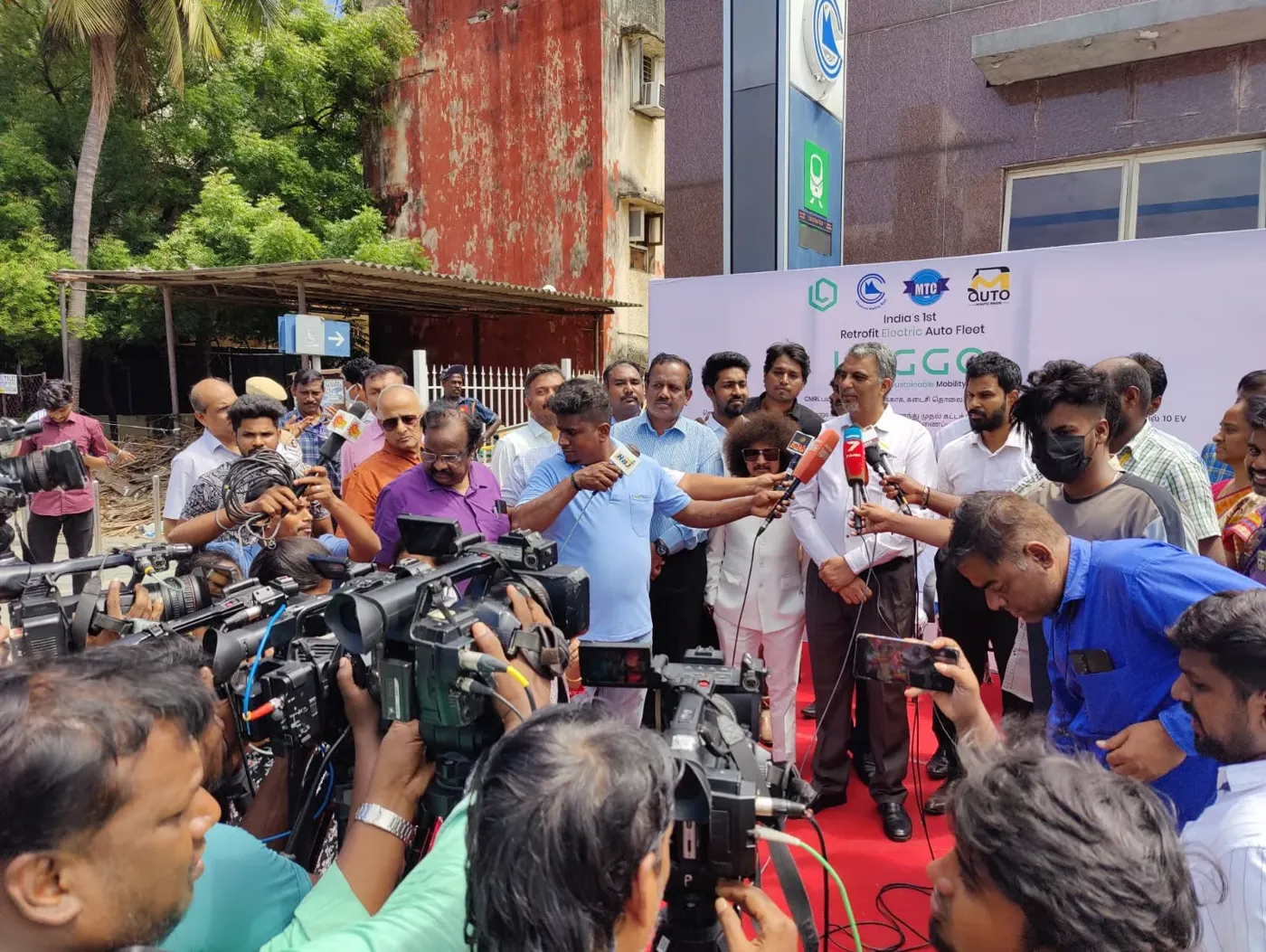 Television crews interviewing the Leggo team at a station launch