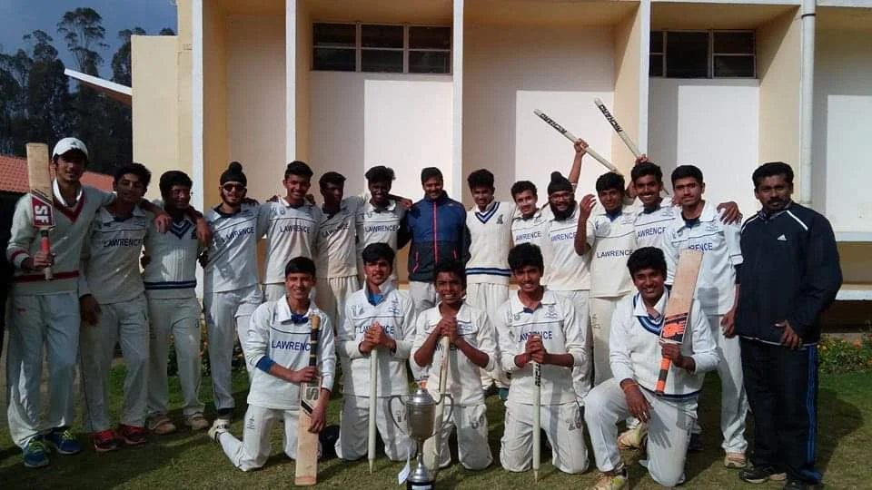 The Lawrence School cricket team with their trophy
