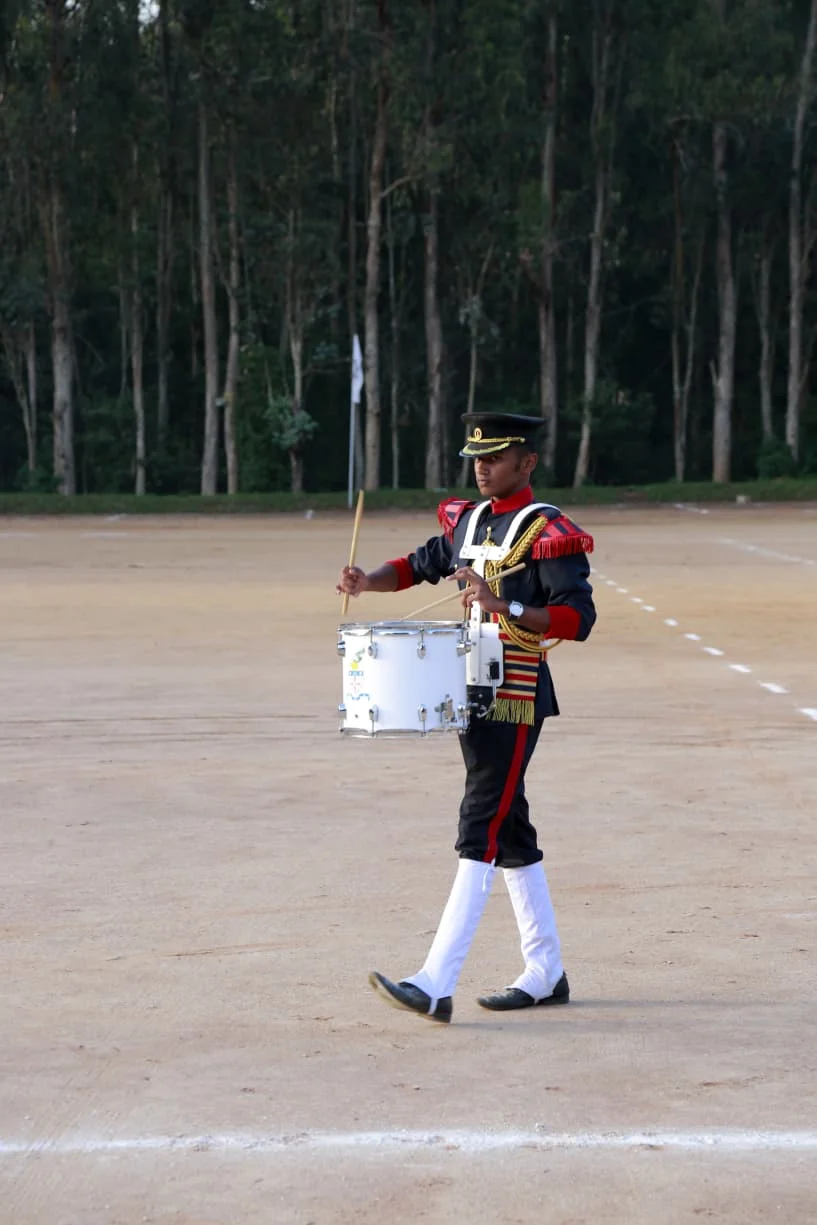 Vidhoo marching with a snare drum